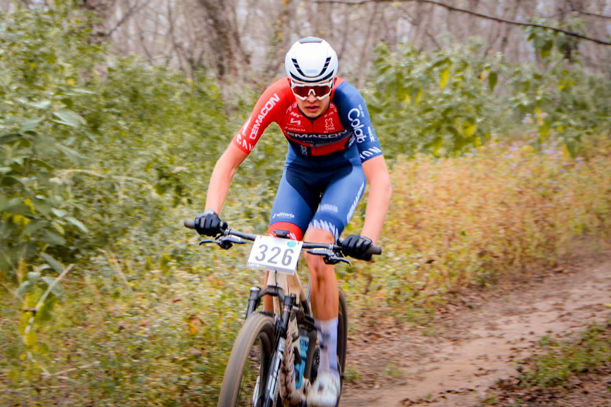 A cross-country rider carving through a corner on a dirt trail